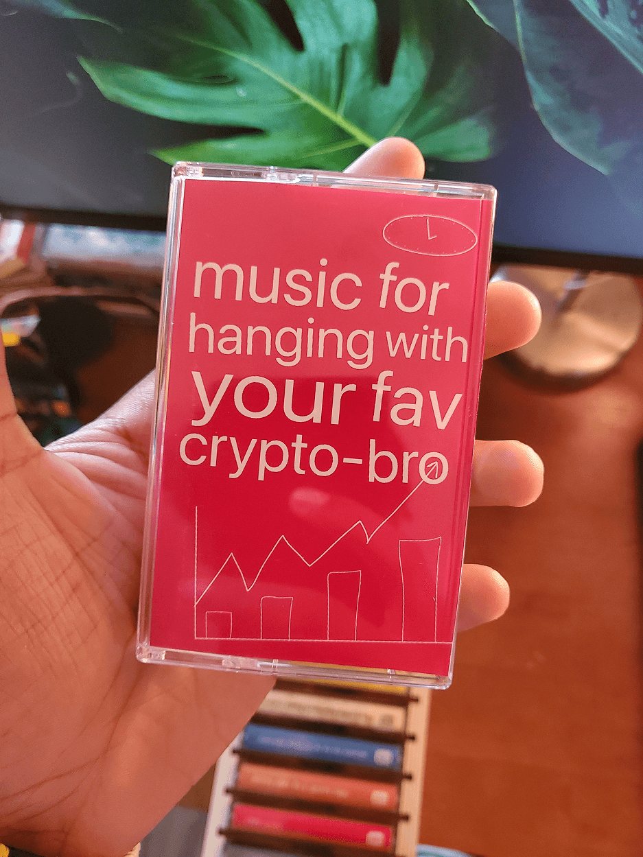 Music for hanging with your fav crypto-bro, hot pink, held in front of the monstera