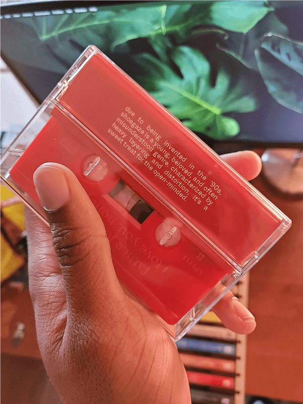 The red shoegaze case from the back, with the red tape and liner notes showing