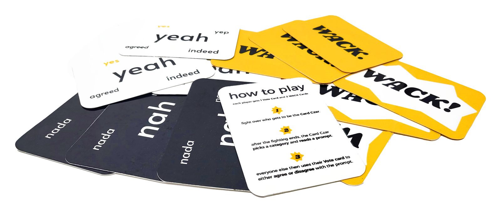Printed cards fanned on a table: black nah and white yeah Vote cards, the how to play card, and a spill of yellow WACK cards