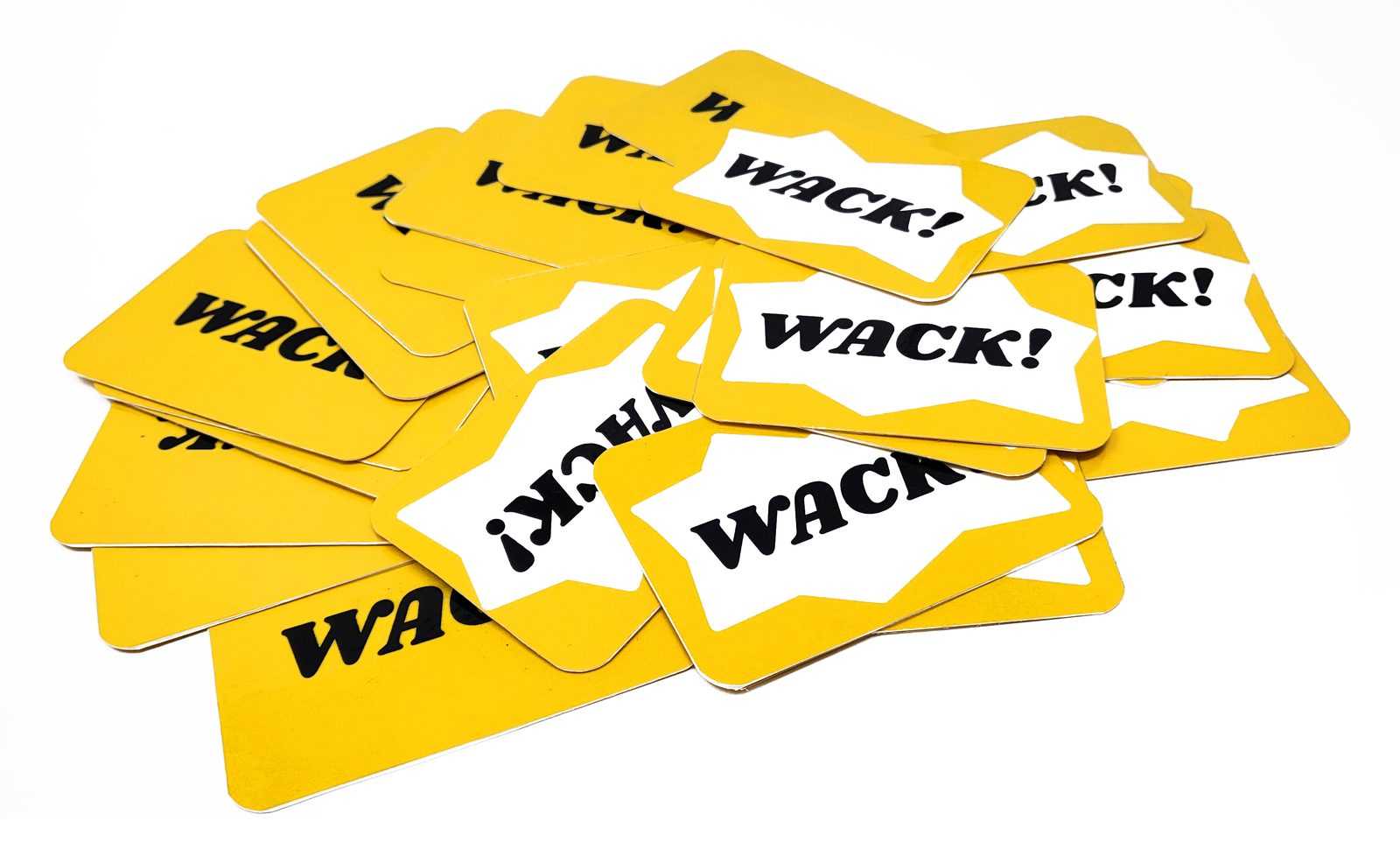 A pile of printed WACK cards, “WACK!” on white star bursts over yellow