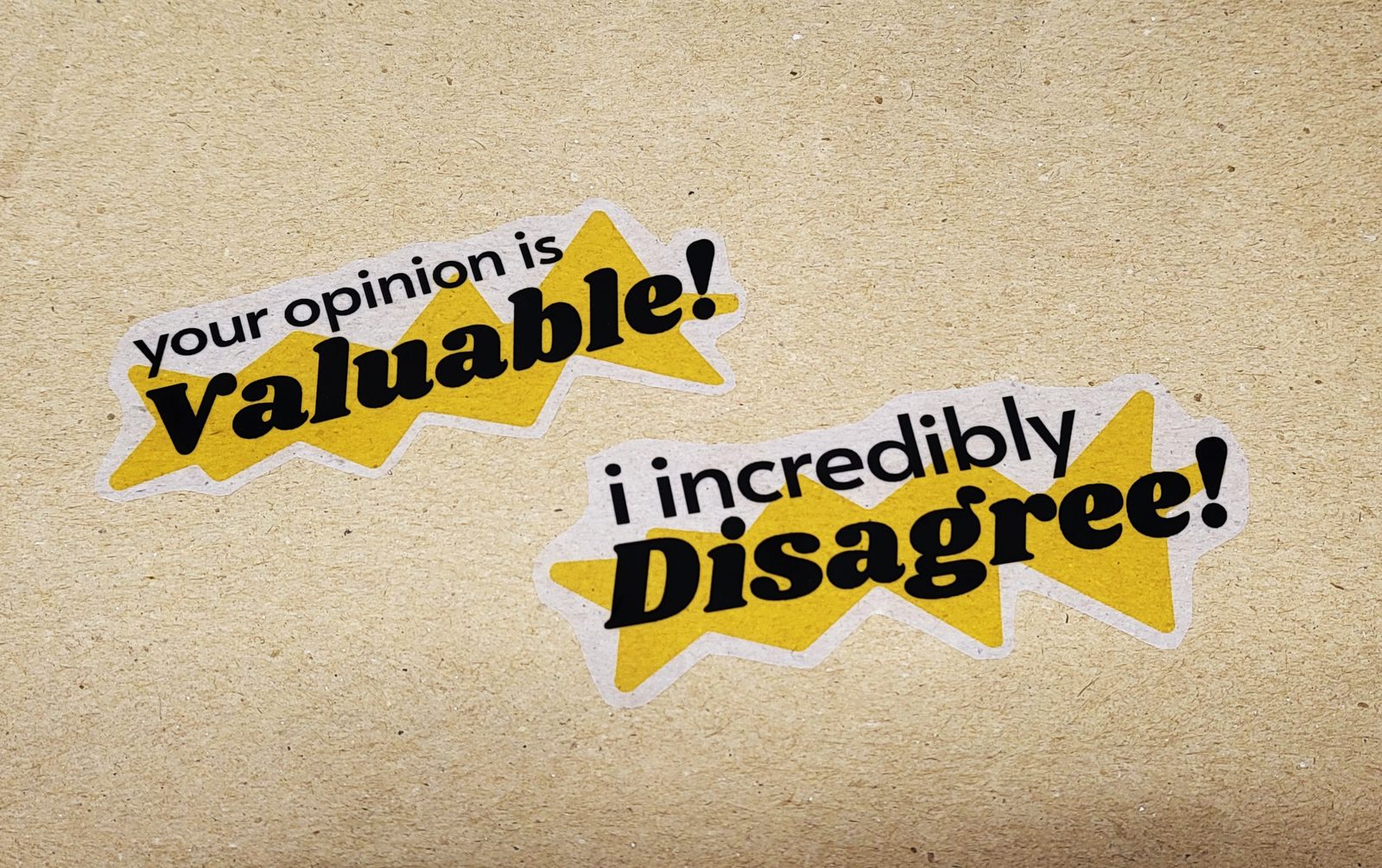 The two quote stickers printed, on kraft paper